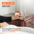 Person reaching for a bottle labeled 'Constetab' and instruction on how to use it